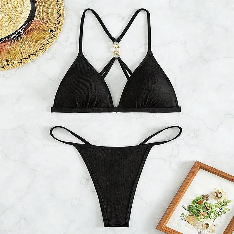 Black women's hollow backless split triangle bikini set with T pants on a mannequin