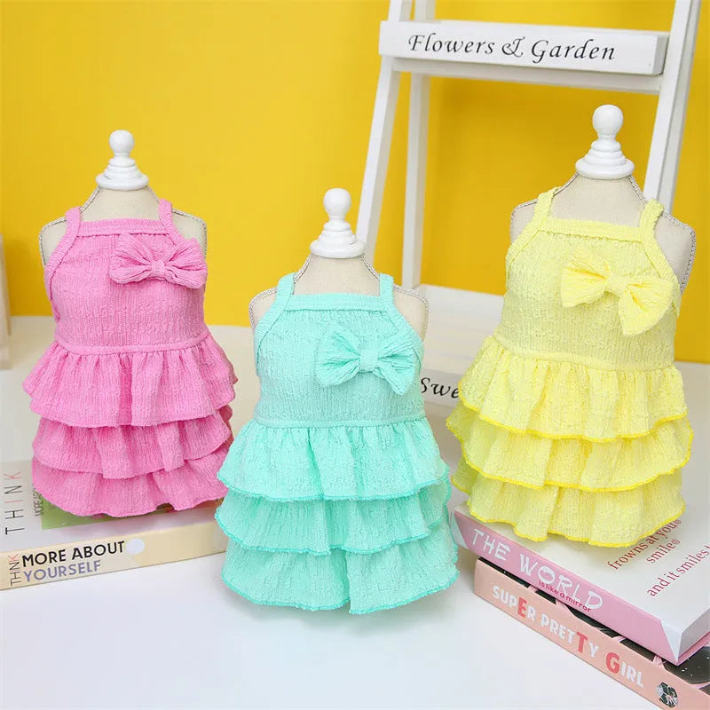Small dog wearing princess dress with candy layered skirt in rose red colour