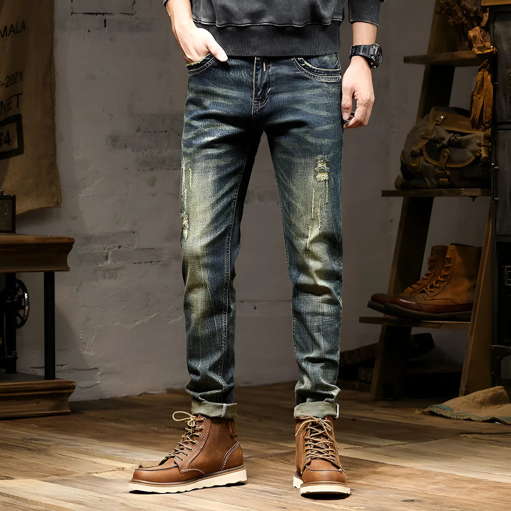 Men's skinny fit jeans in retro blue denim with a zip fly, shown laid flat.