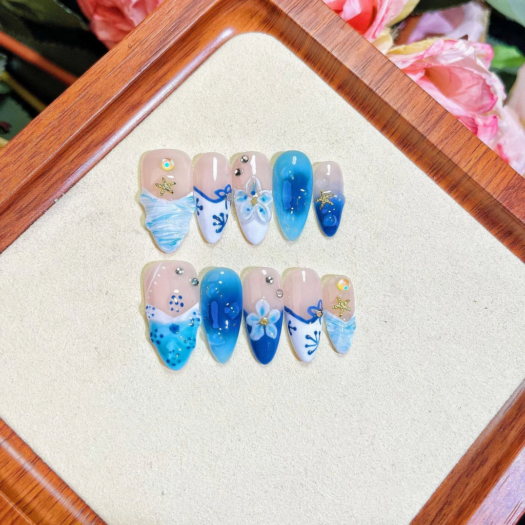 Set of blue hand-painted carved summer ice transparent plastic fake nails in sizes XS, S, M, L.