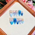 Set of blue hand-painted carved summer ice transparent plastic fake nails in sizes XS, S, M, L.
