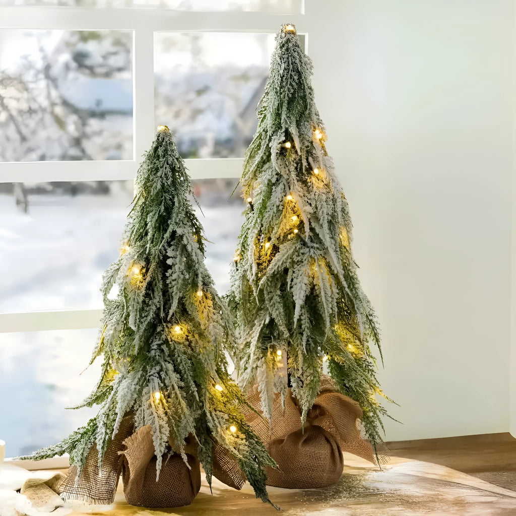 Small 24-inch artificial Christmas tree with LED lights and snow sprayer ornament on desktop