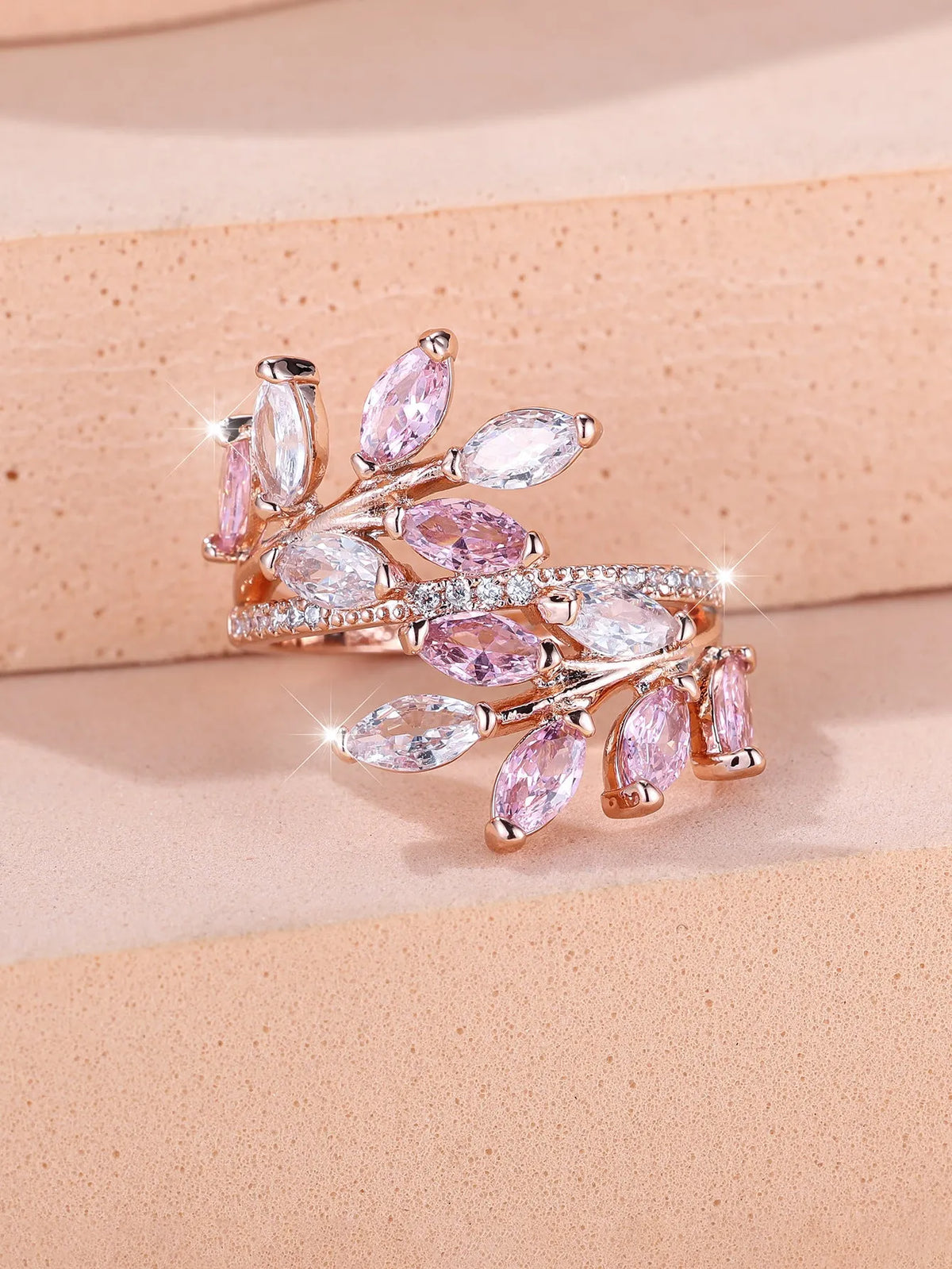 Adjustable copper leaf ring with zircon detailing in multiple colour options on display