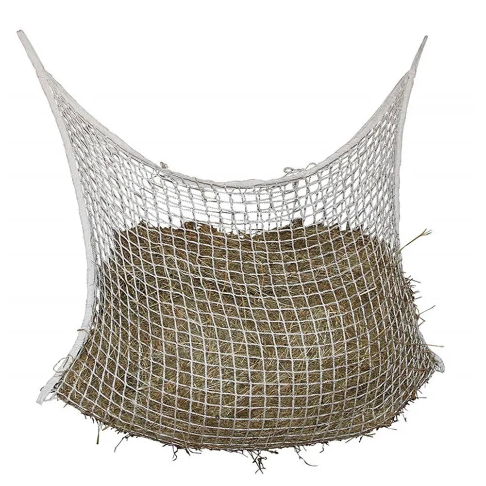 Black woven PE rope horse feeding bag with grid design hanging in stable