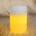 White cylindrical mini humidifier with USB cable on a desk