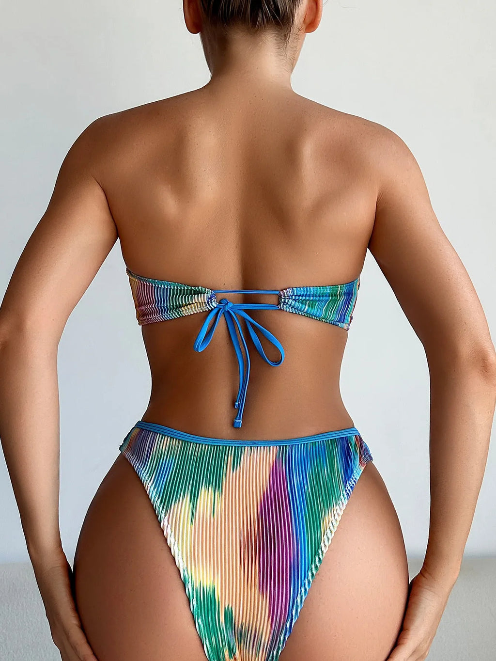 Colour printed polyester tube top bikini set with matching briefs on a mannequin.