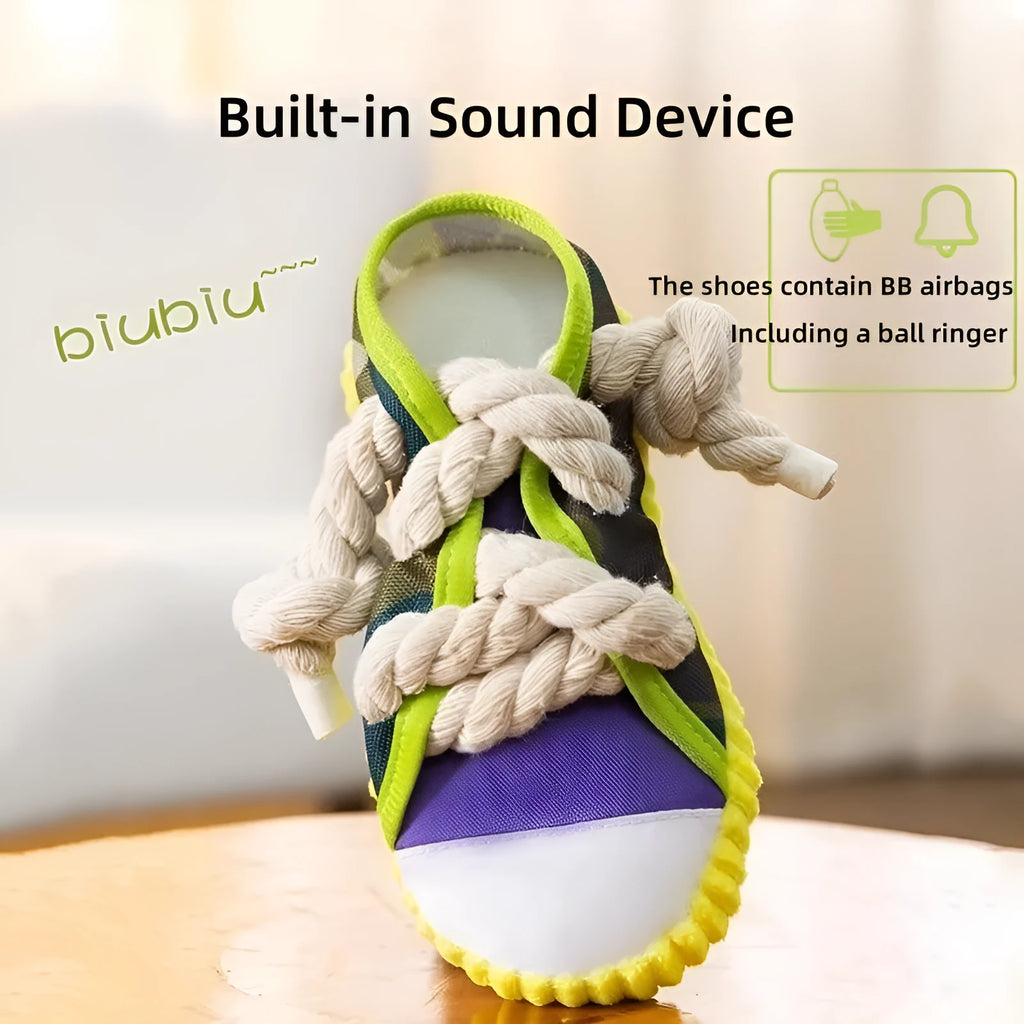 Realistic shoe-shaped dog toy in grey, purple, or yellow with laces, sole patterns, built-in squeaker and bell.