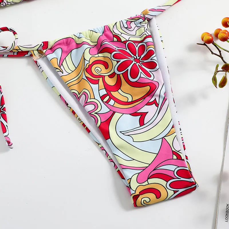 Women's multicolour triangle printed bikini with halter neck top and separate bottoms.
