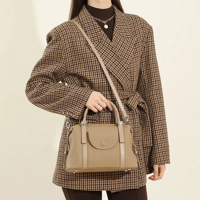 Genuine leather ladies shoulder bag in street trend style with lock detail and contrast stitching.