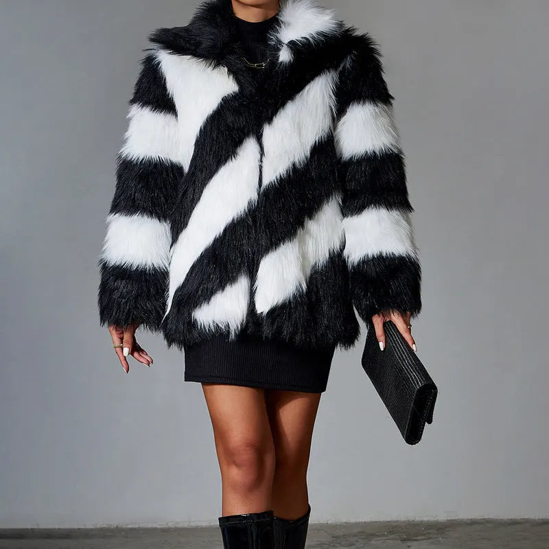 Women's beige faux fur lapel coat with a dark contrast fur collar on a hanger.