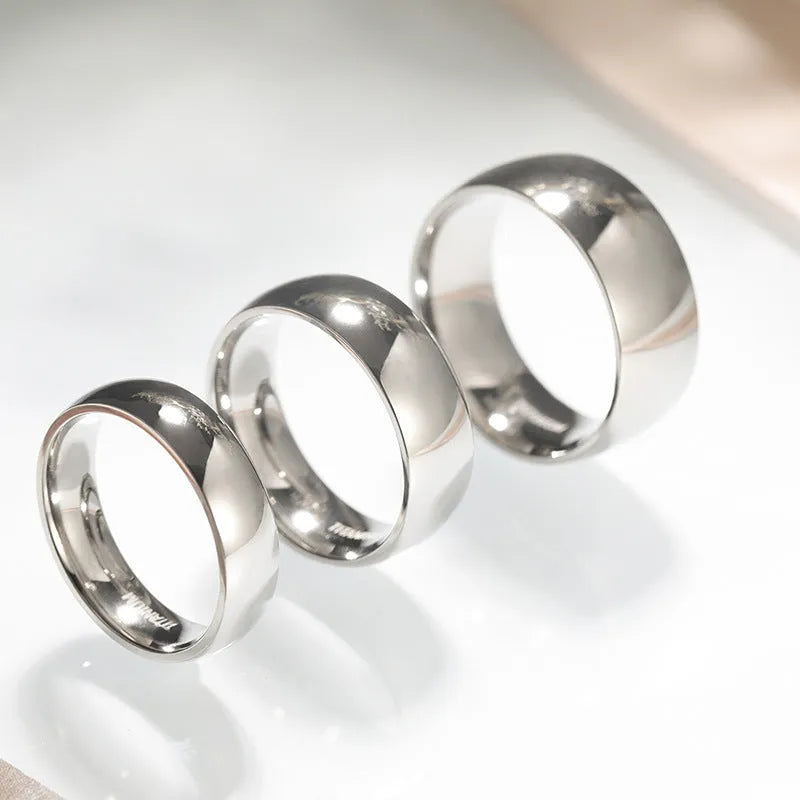 Polished silver titanium steel unisex ring showing 2mm 4mm 6mm width options with US sizing