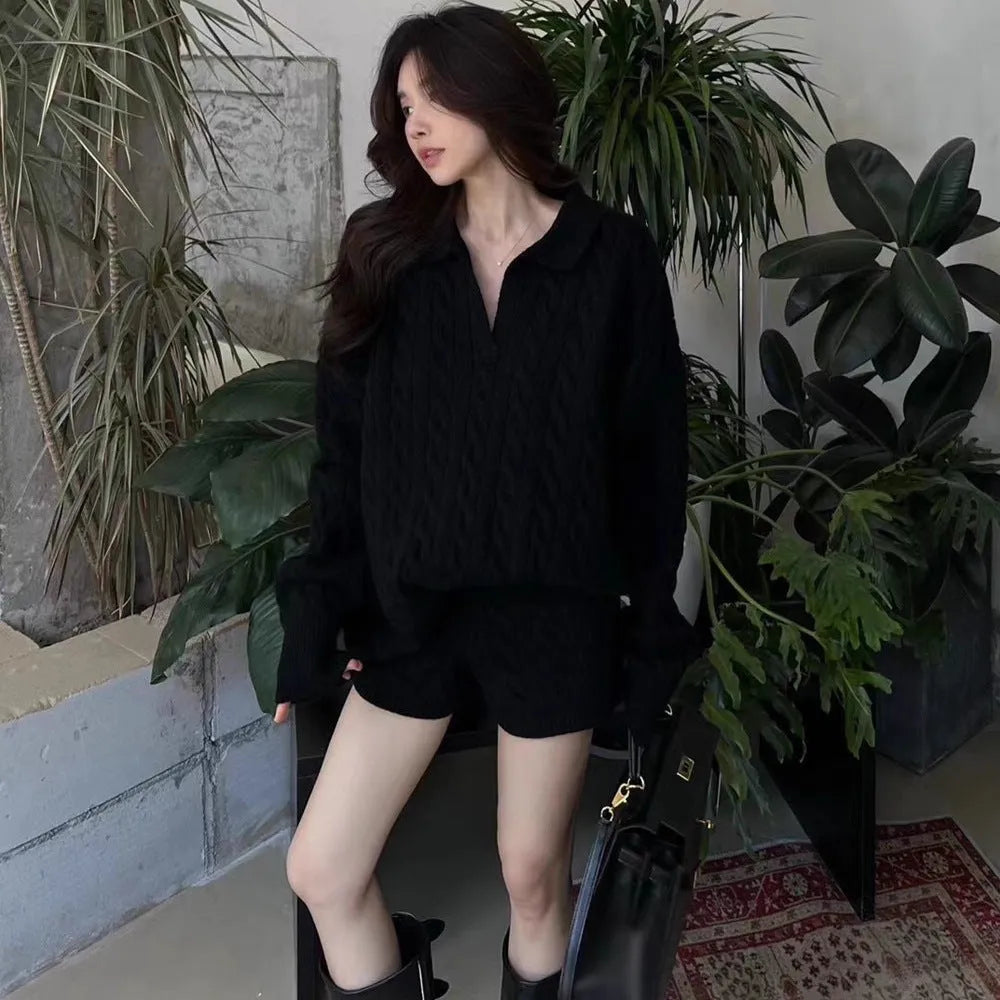 Women's creamy-white knitted suit set with geometric cable pattern, long sleeve sweater, and elastic waist shorts