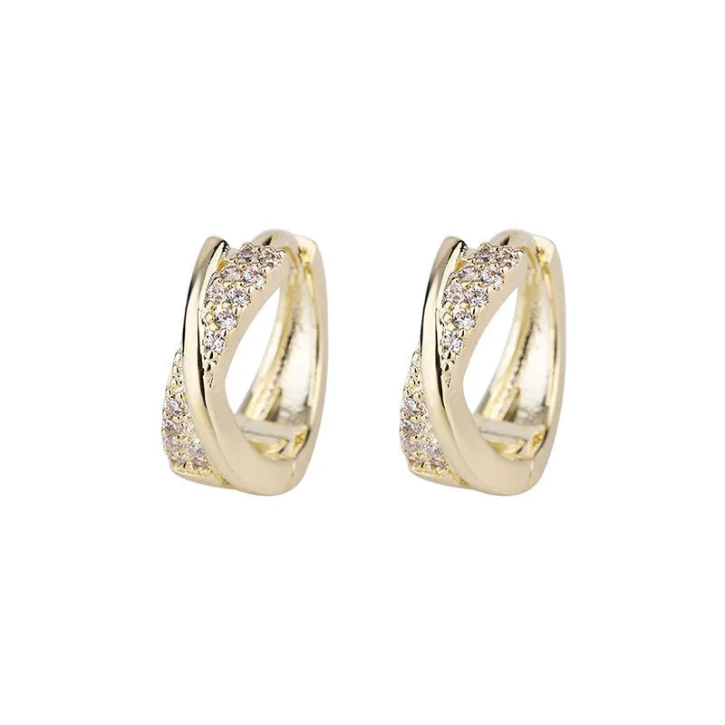 A pair of geometric drop earrings in 14K yellow gold colour, made from copper with a zircon treatment detail.