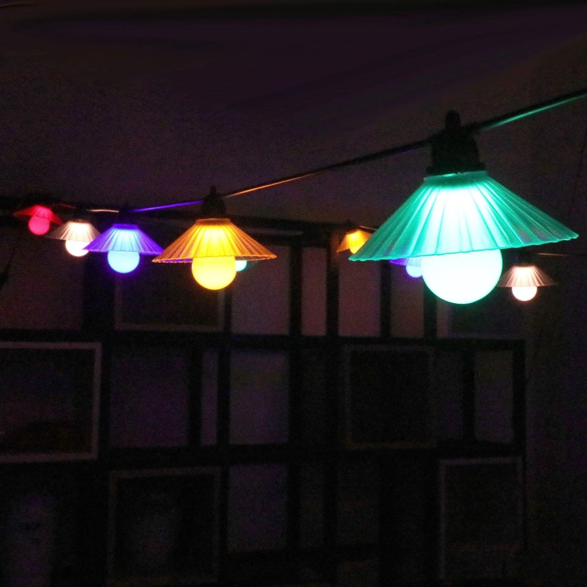 Outdoor LED string lights with flower-shaped globes shown in warm white and multi-colour settings.