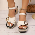 Women's white chunky heel sandals with a metal buckle and square toe on a rubber sole.