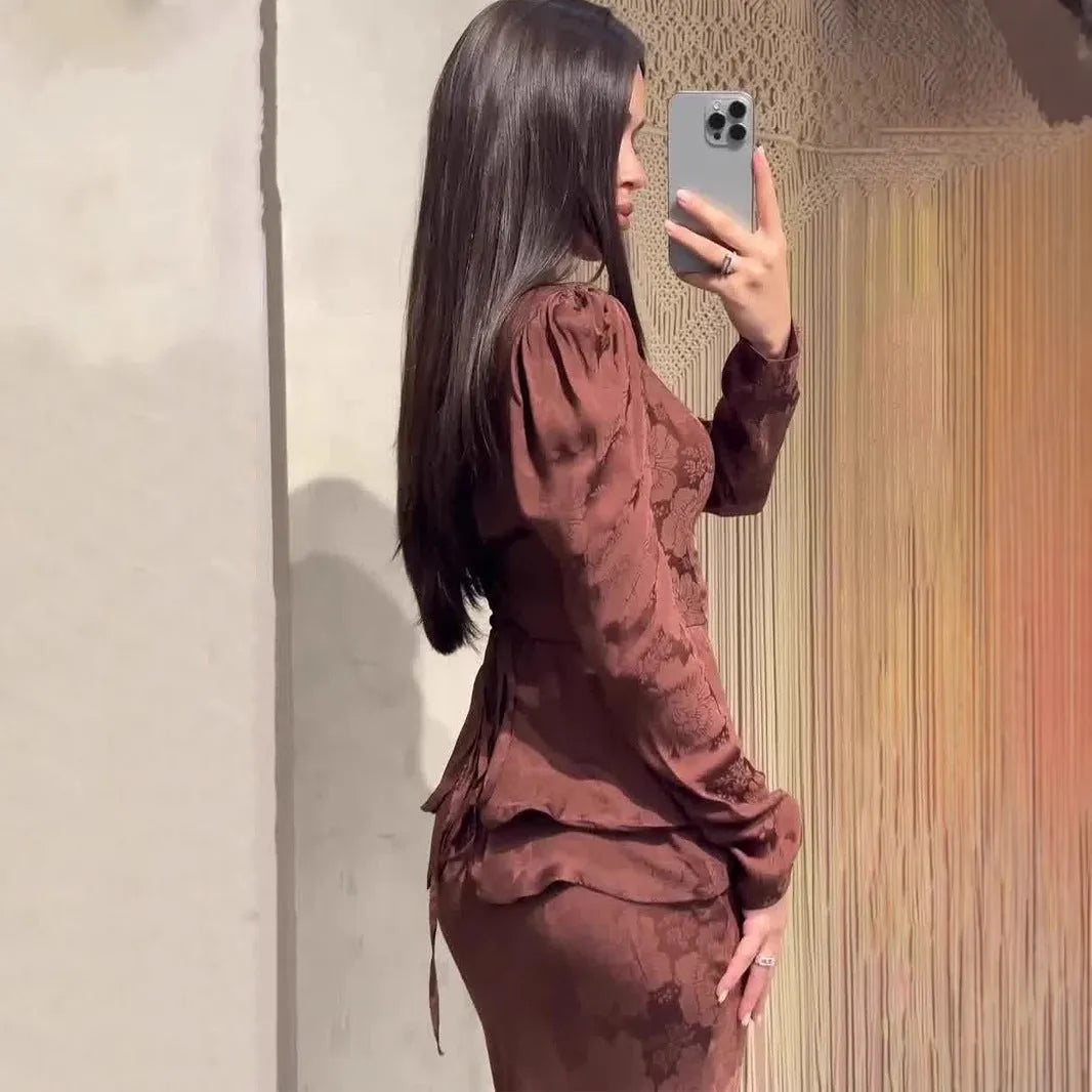 Dark brown retro dress with floral print, long sleeves, button detail, and a fake two-piece silhouette.