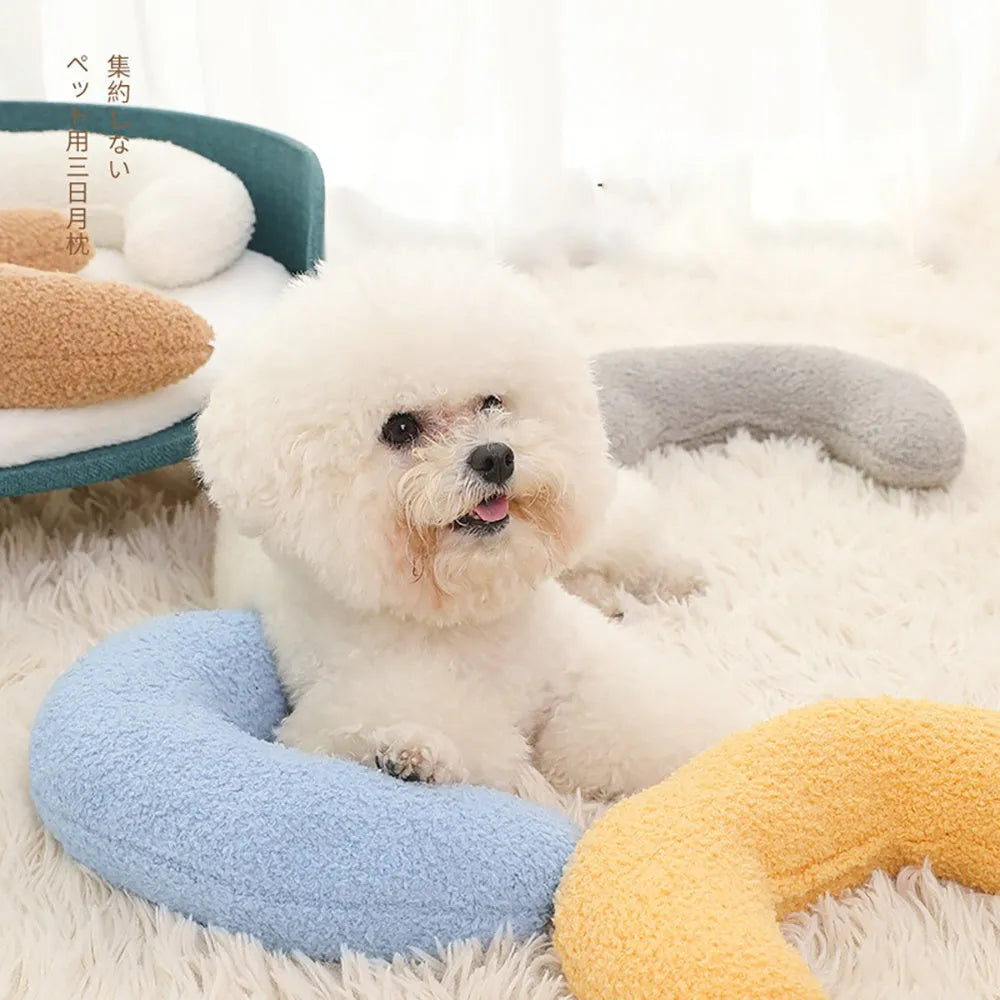 U-shaped blue cat pillow with adjustable fabric collar on a sofa