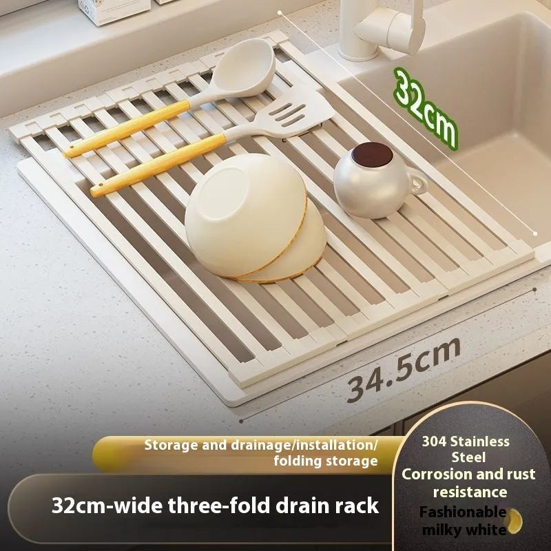 Milky white foldable stainless steel kitchen draining rack shown unfolded next to a sink.