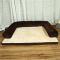 Grey corduroy dog sofa bed with bilateral bolsters on a wooden floor.