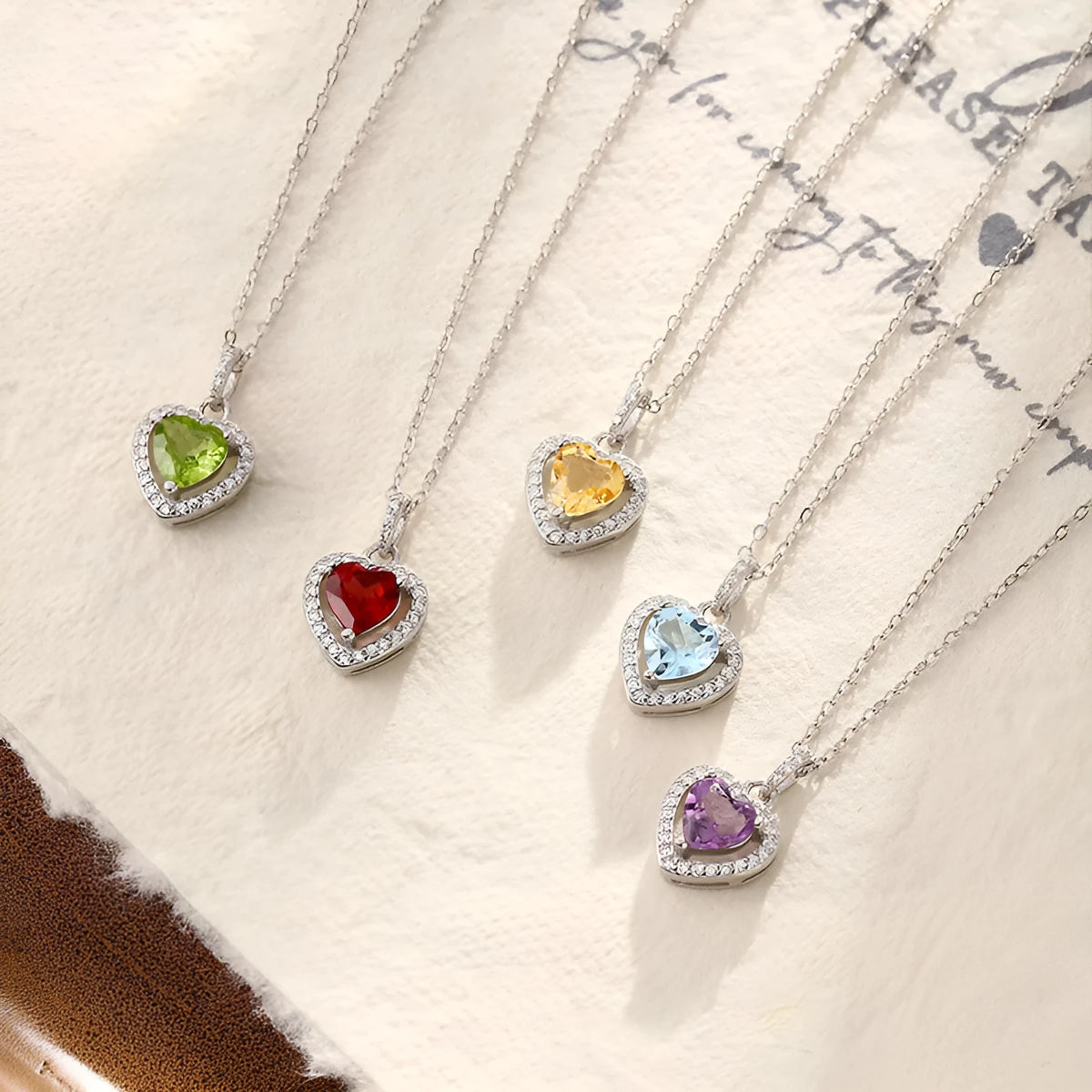 Sterling silver necklace with heart-shaped natural gemstone pendant on adjustable cross chain