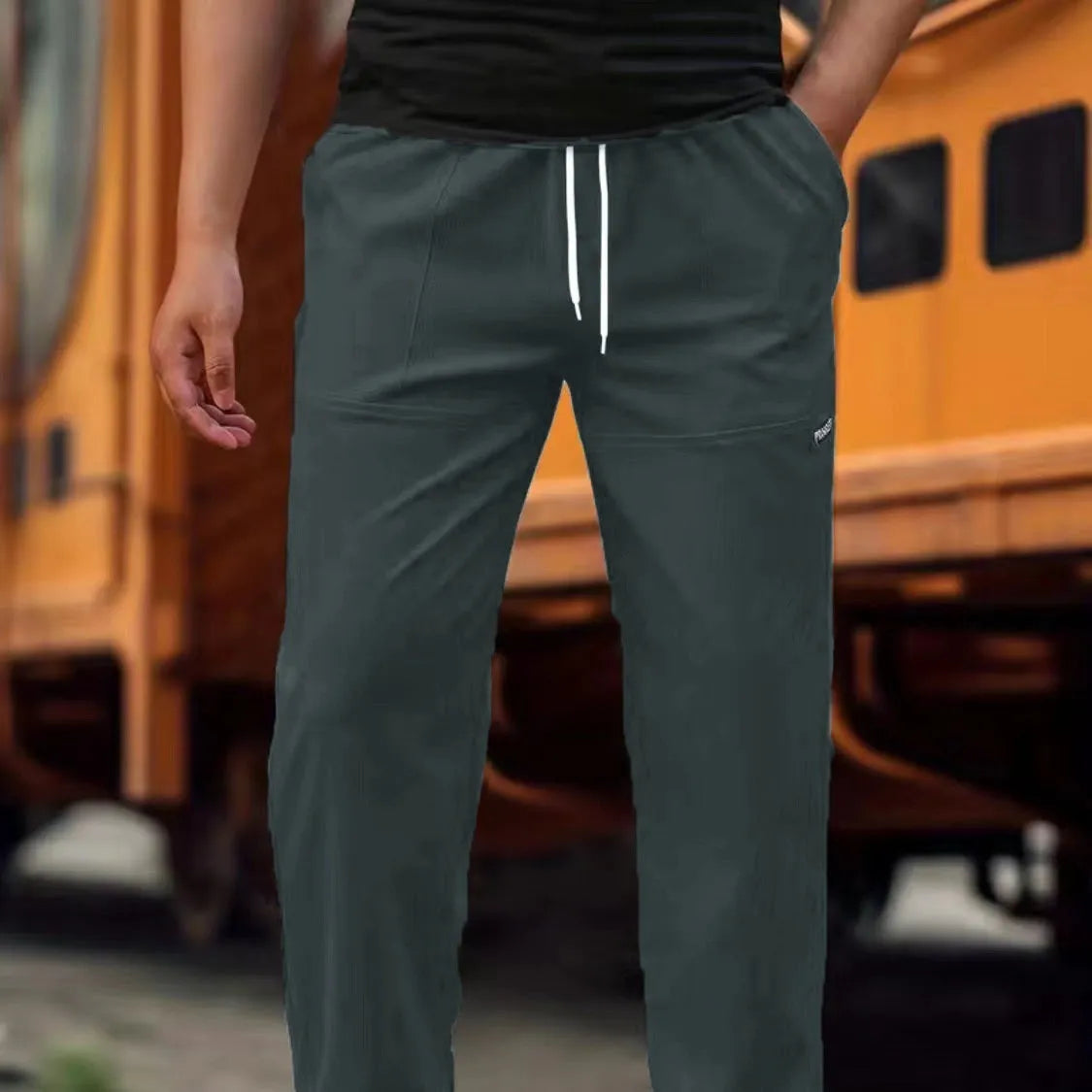 Men's polyester trousers for spring and autumn in light grey colour, showing casual fit.