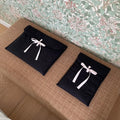 Women's black quilted computer bag with ballet bow and striped lining