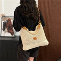 Black knitted bucket tote bag with contrast stitching showing internal zipper compartment