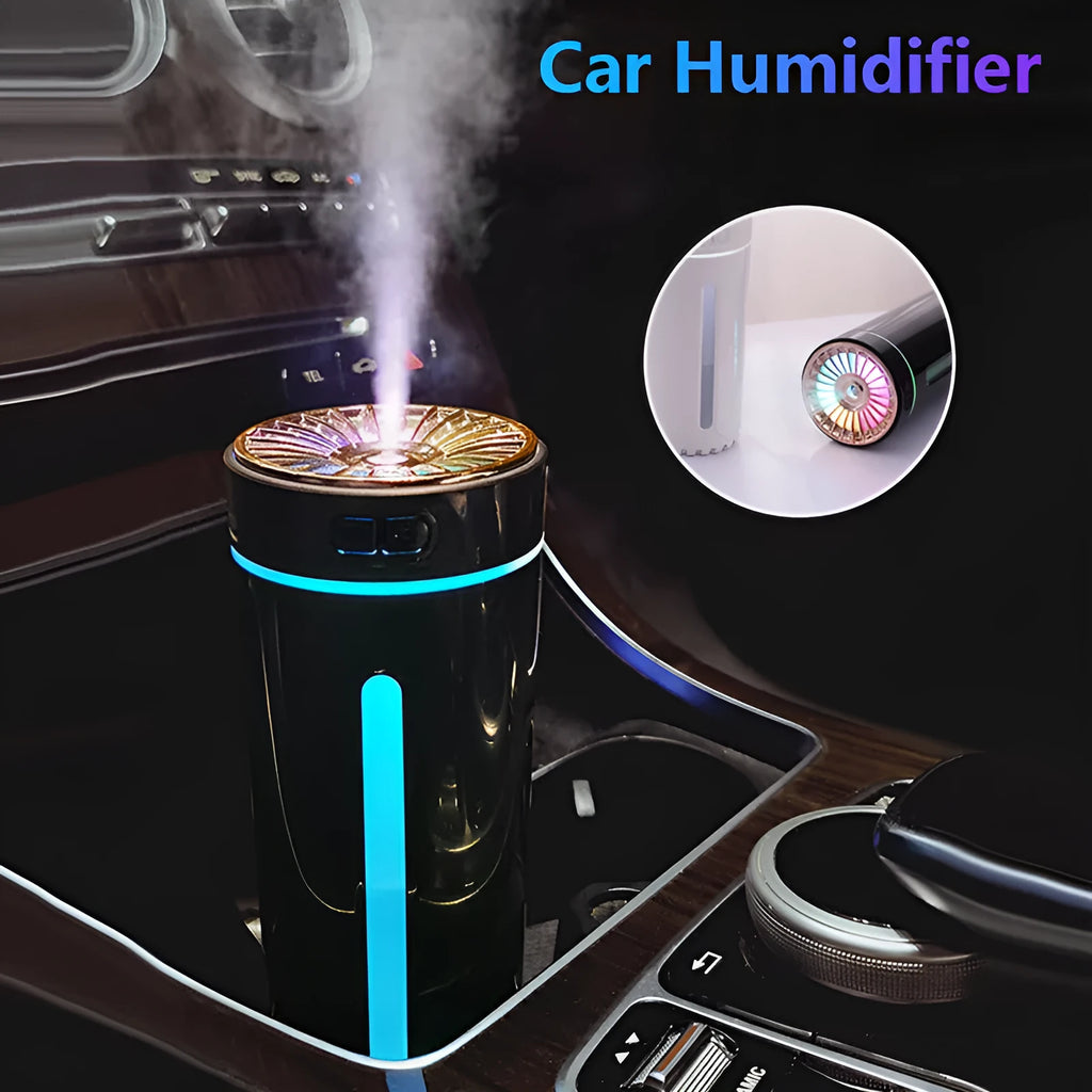 Black wireless ultrasonic humidifier with colourful lights, shown next to a USB cable on a desk.