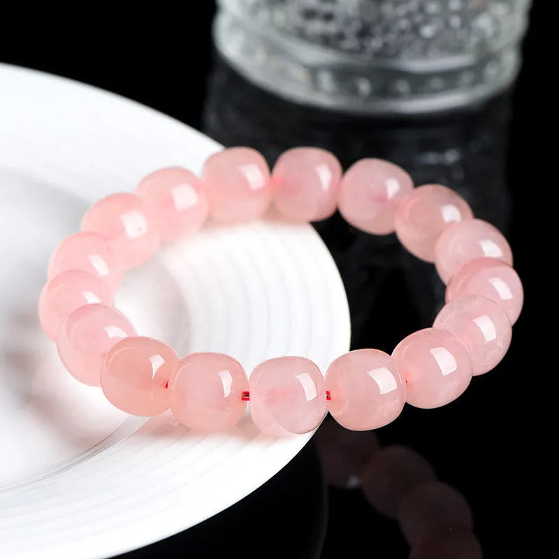 Pink crystal barrel bead bracelet with geometric 8x10mm beads on wrist