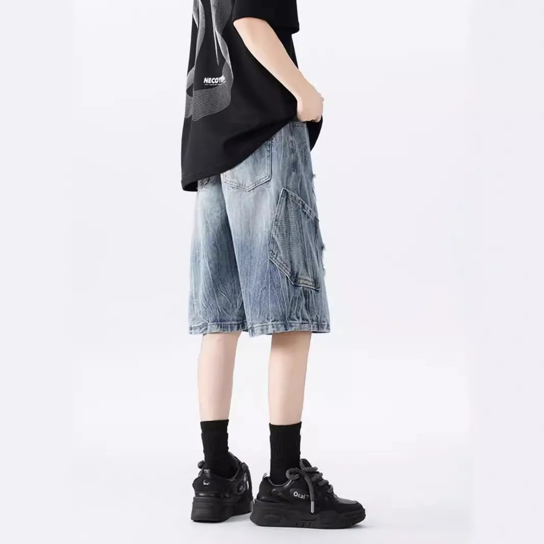 Washed blue denim shorts with ripped detailing on a hanger, showing loose retro fit