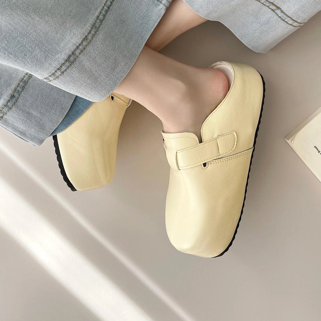 Flat buckle casual sneakers in yellow, creamy-white, silver, and black colours on a white background.
