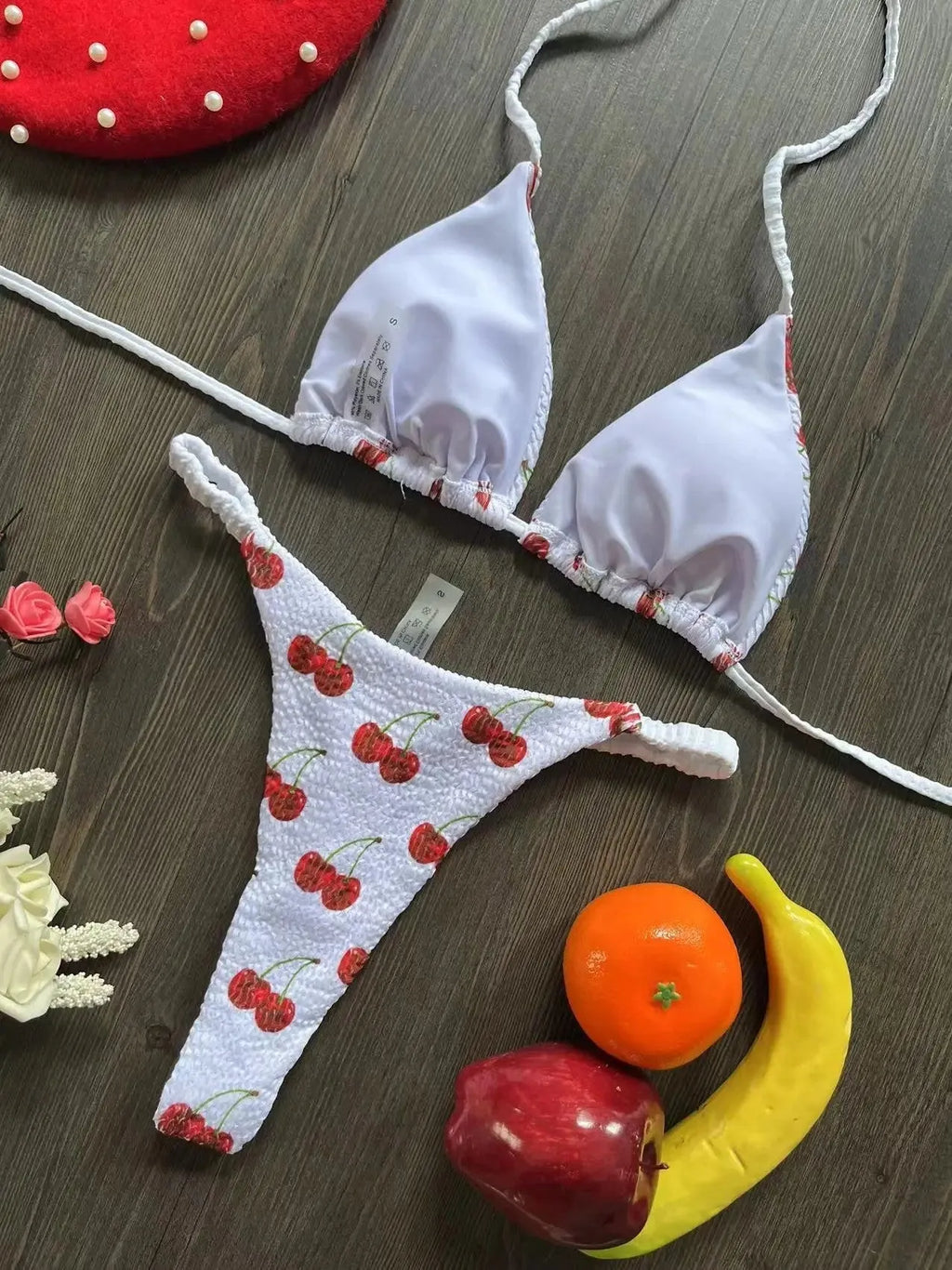 Women's printed bikini swimsuit set on a hanger, showing quick-dry fabric and cotton-lined briefs.