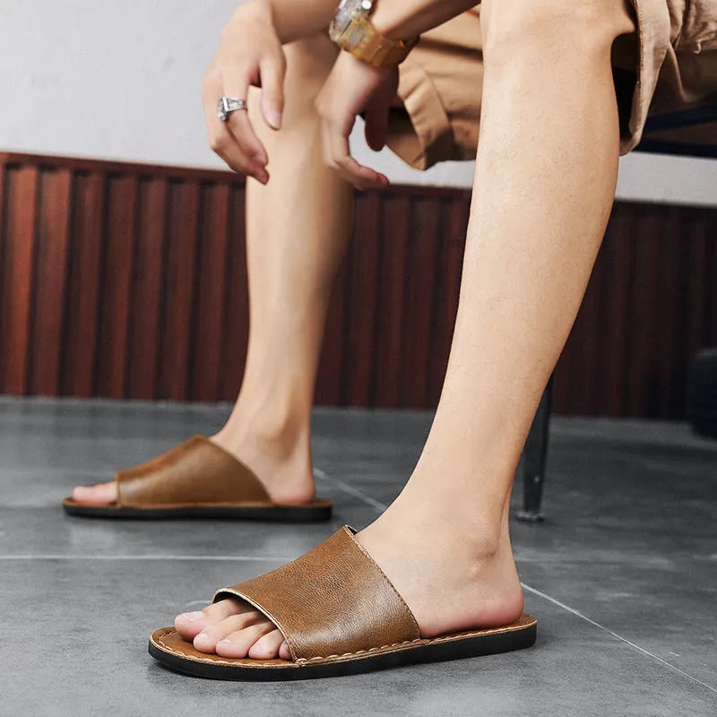 Men's brown leather sandals with rubber soles showing open-toe design