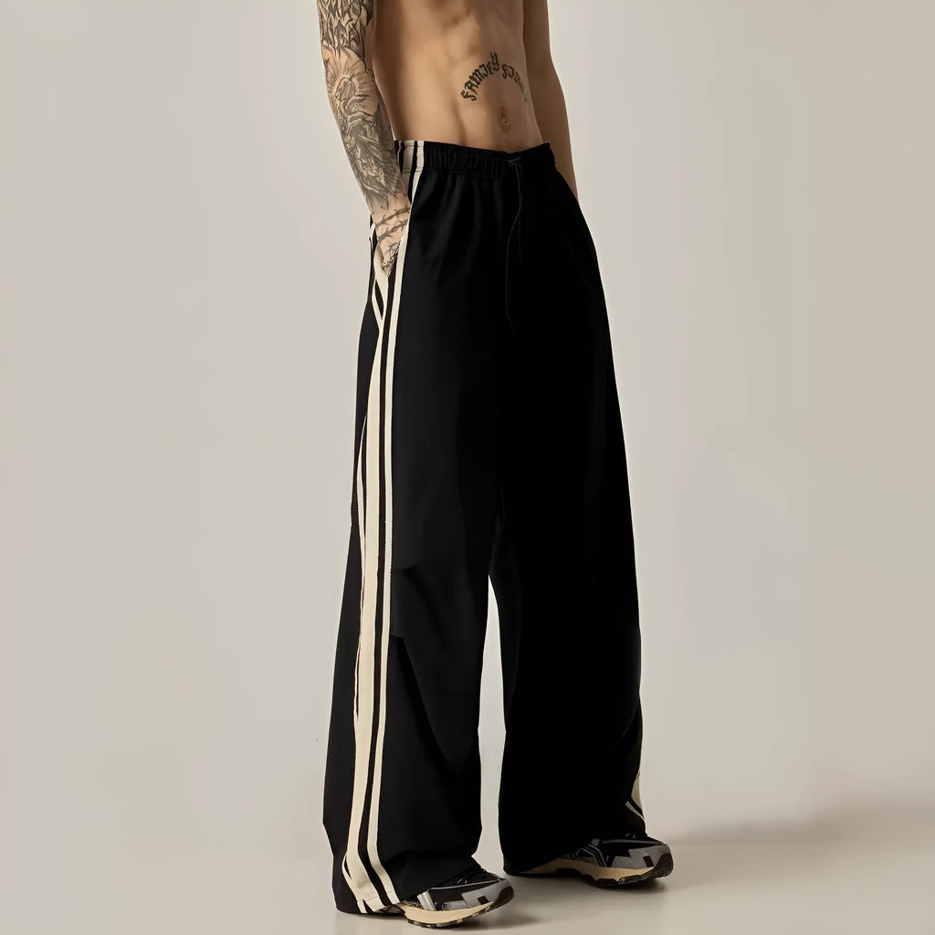 Black wide leg climbing trousers with high waist and straight leg design on hanger