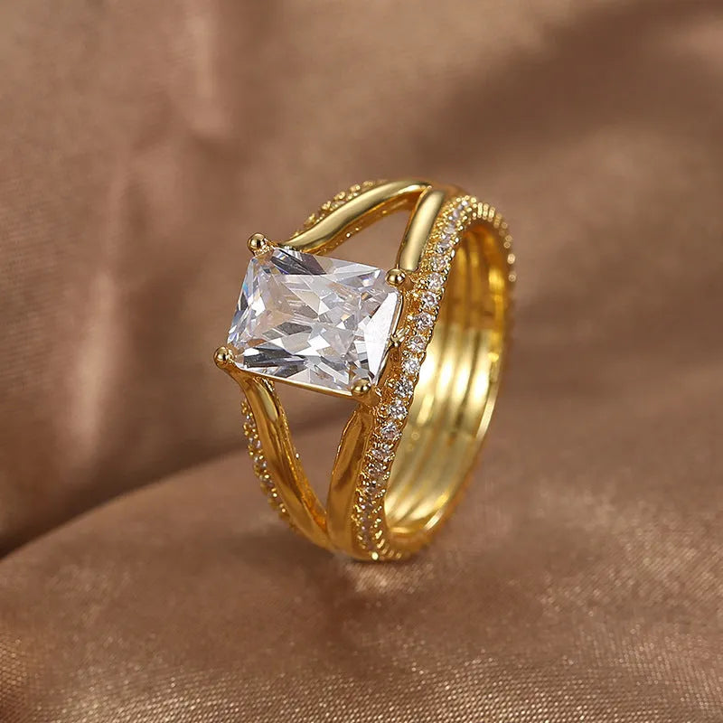 Gold square zircon geometric ring on finger showing electroplated copper construction