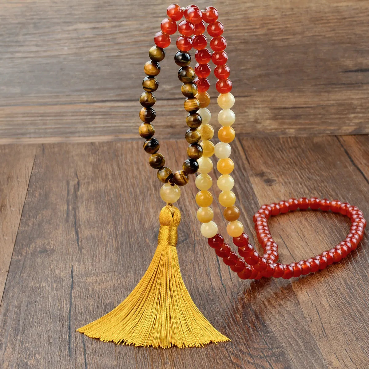 Handmade long beaded necklace with gemstone pendant and tassel, showing 81cm+ length.