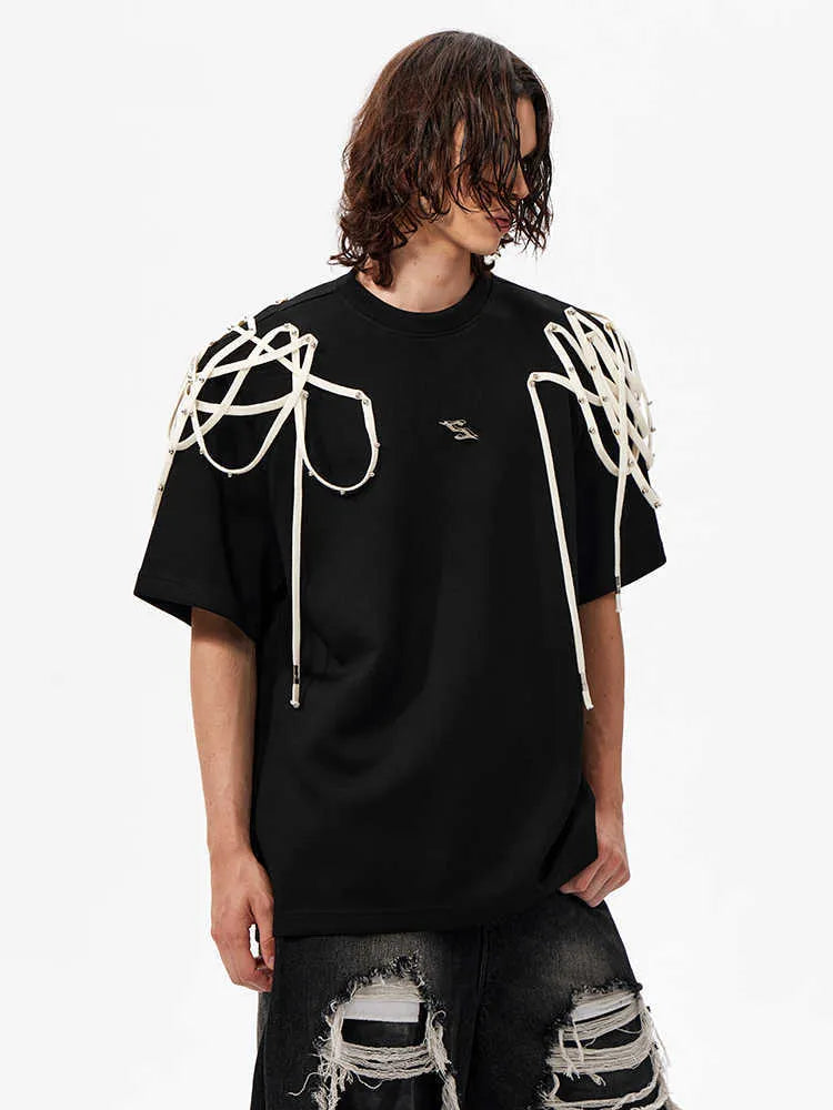 Black loose fit short-sleeved t-shirt with padded shoulder detail and rivet ribbon accents