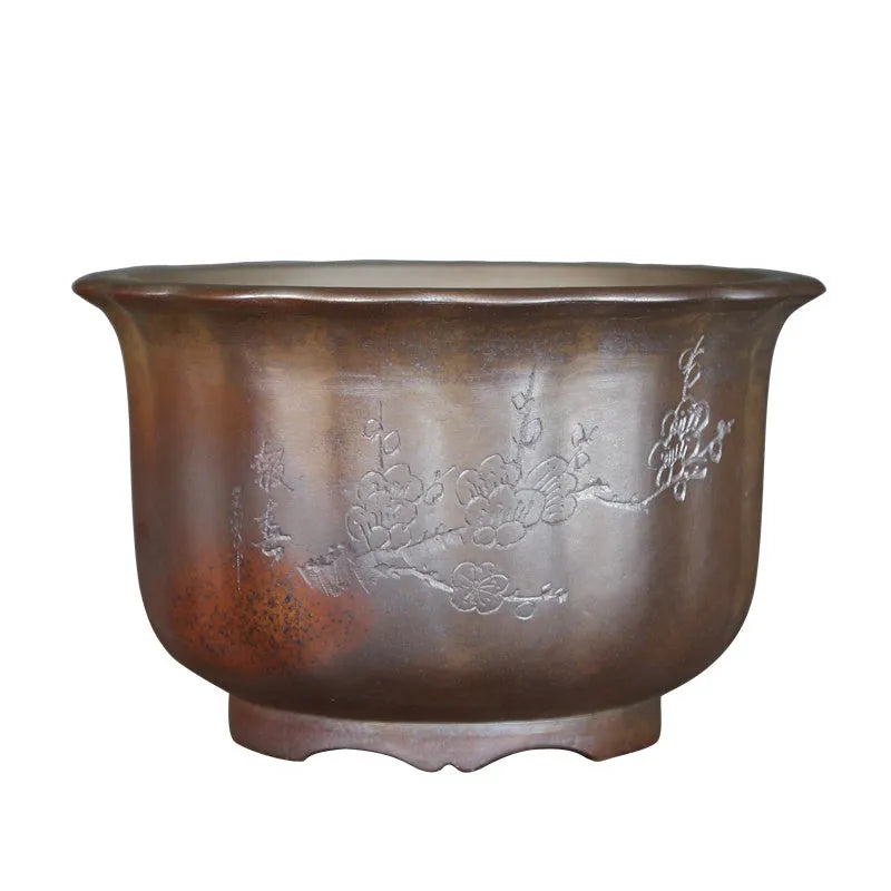 Large antique carved ceramic flower pot in purple sand clay with classical styling for indoor plants