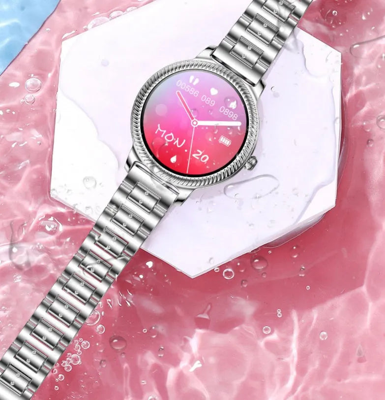 AK38 ladies smart watch with stainless steel Milanese band on a wrist, showing the 1.09-inch colour screen.