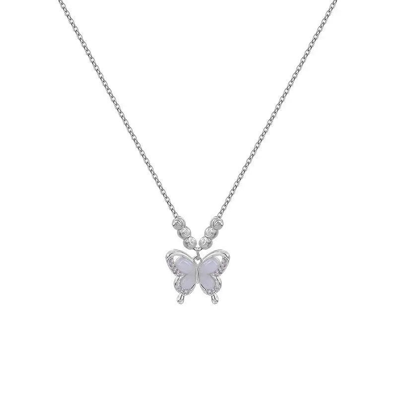 Close-up of a women's square line opal butterfly pendant on a silver adjustable cross chain necklace.