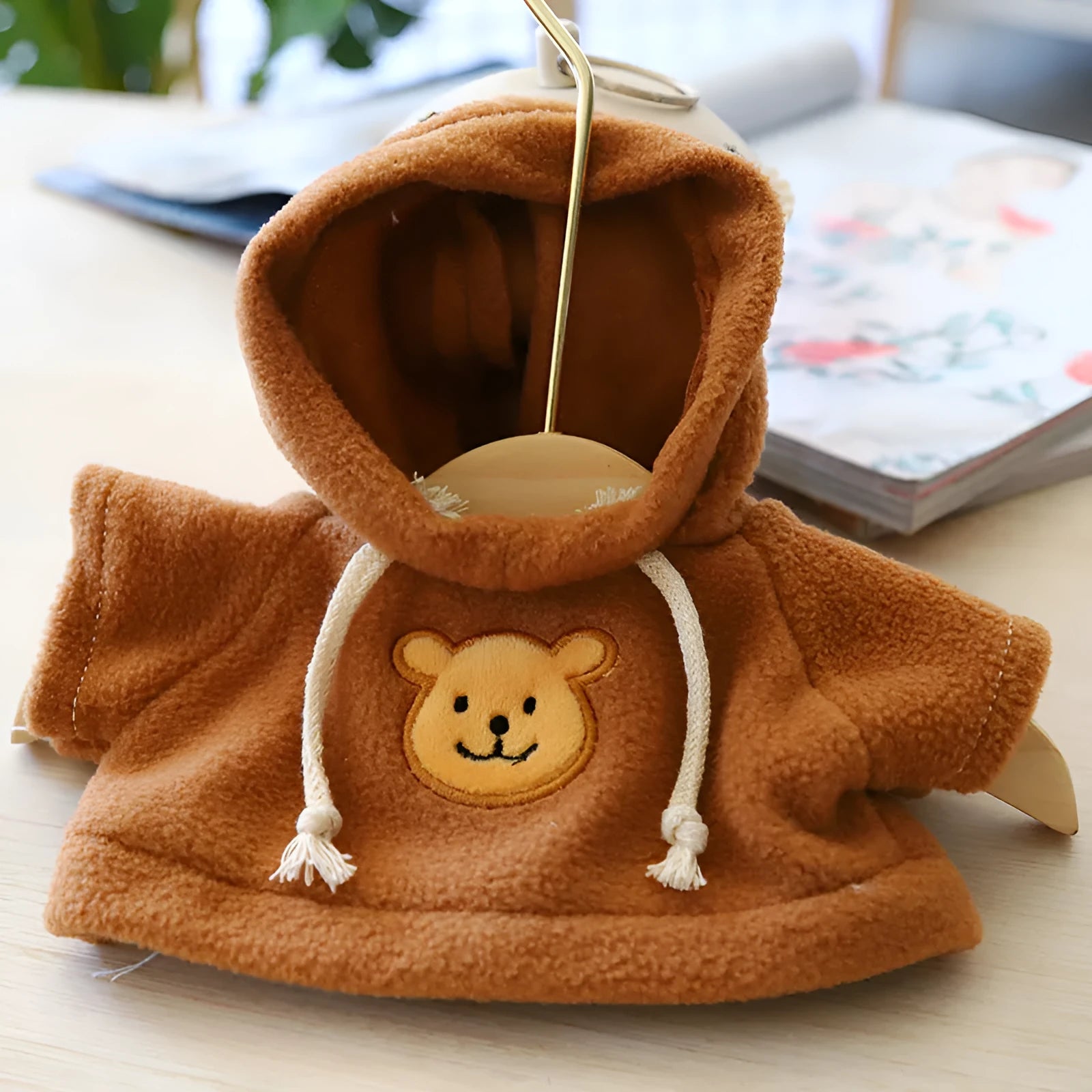 Dog wearing a cloth balaclava hoodie sweater available in blue, pink, red, yellow, brown, or grey bear design