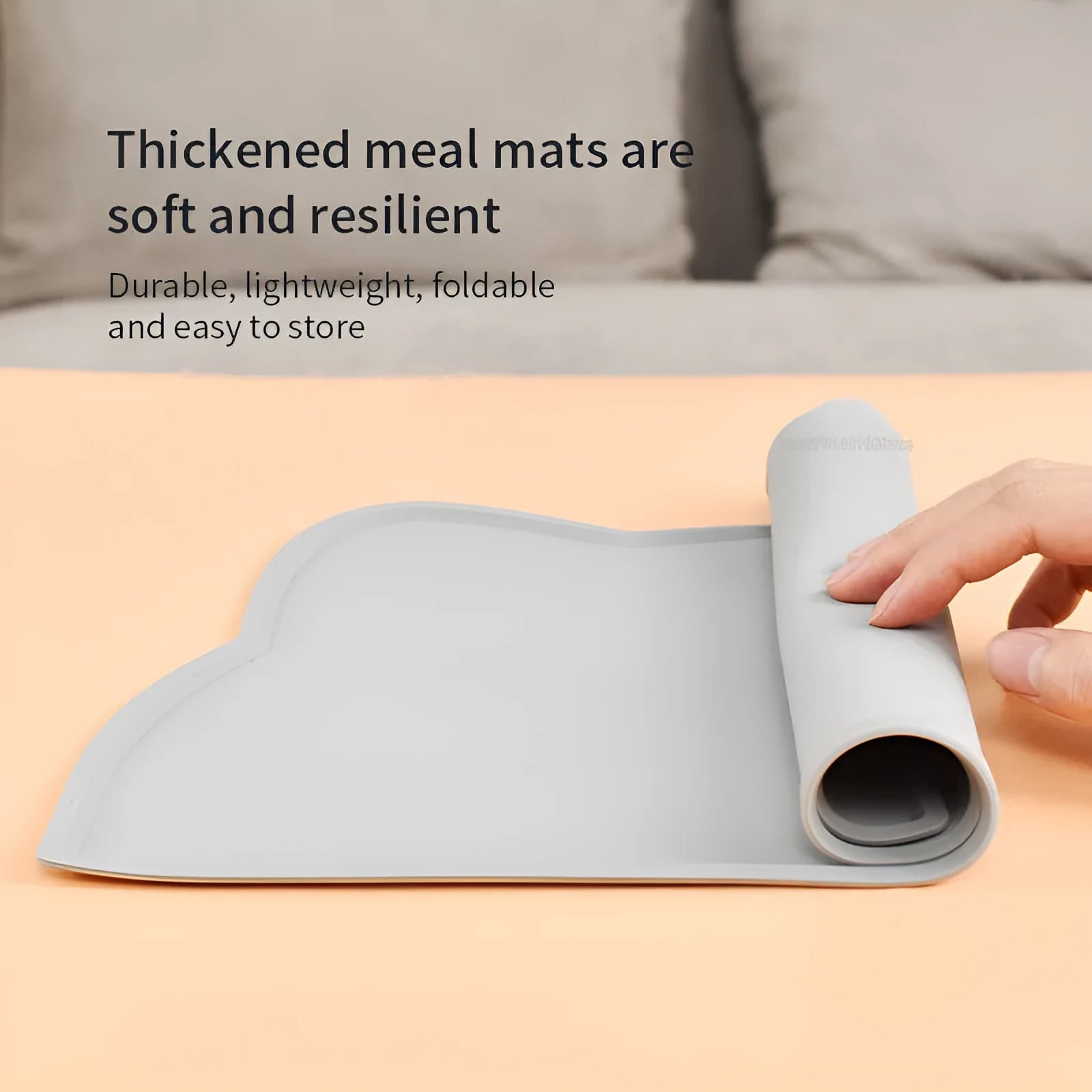 Blue silicone pet feeding mat with cat head shape under food and water bowls
