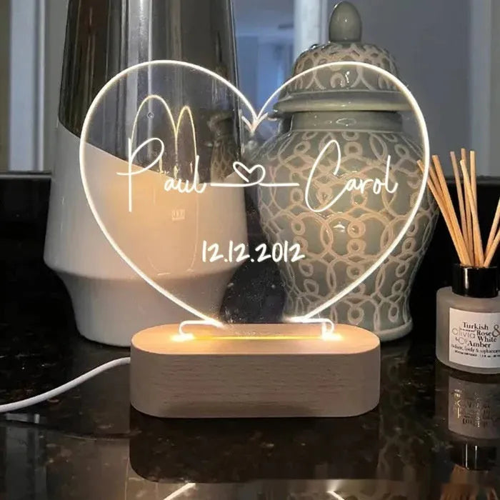 Custom couple names and date engraved on a transparent acrylic LED night light.