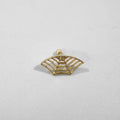 Close-up of metal spider web geometric mesh design stud earrings in a gold electroplated finish.