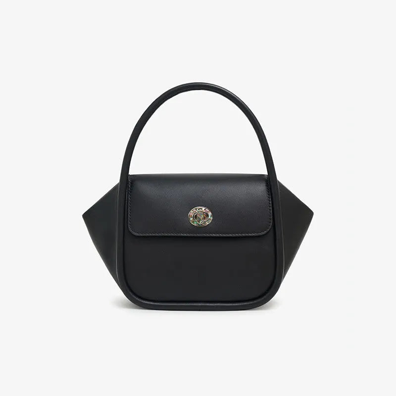 A wing-shaped women's leather tote bag with a buckle latch, shown in blue with a cross-body strap.
