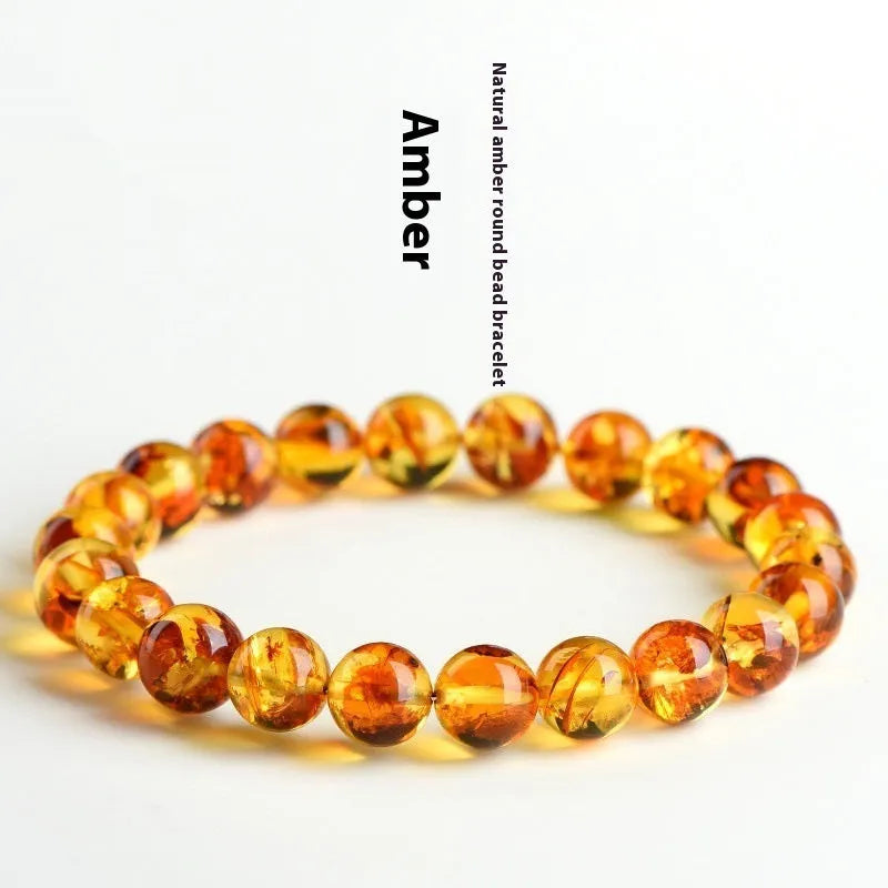 Natural yellow piebald amber bracelet with polished geometric beads on a wrist.