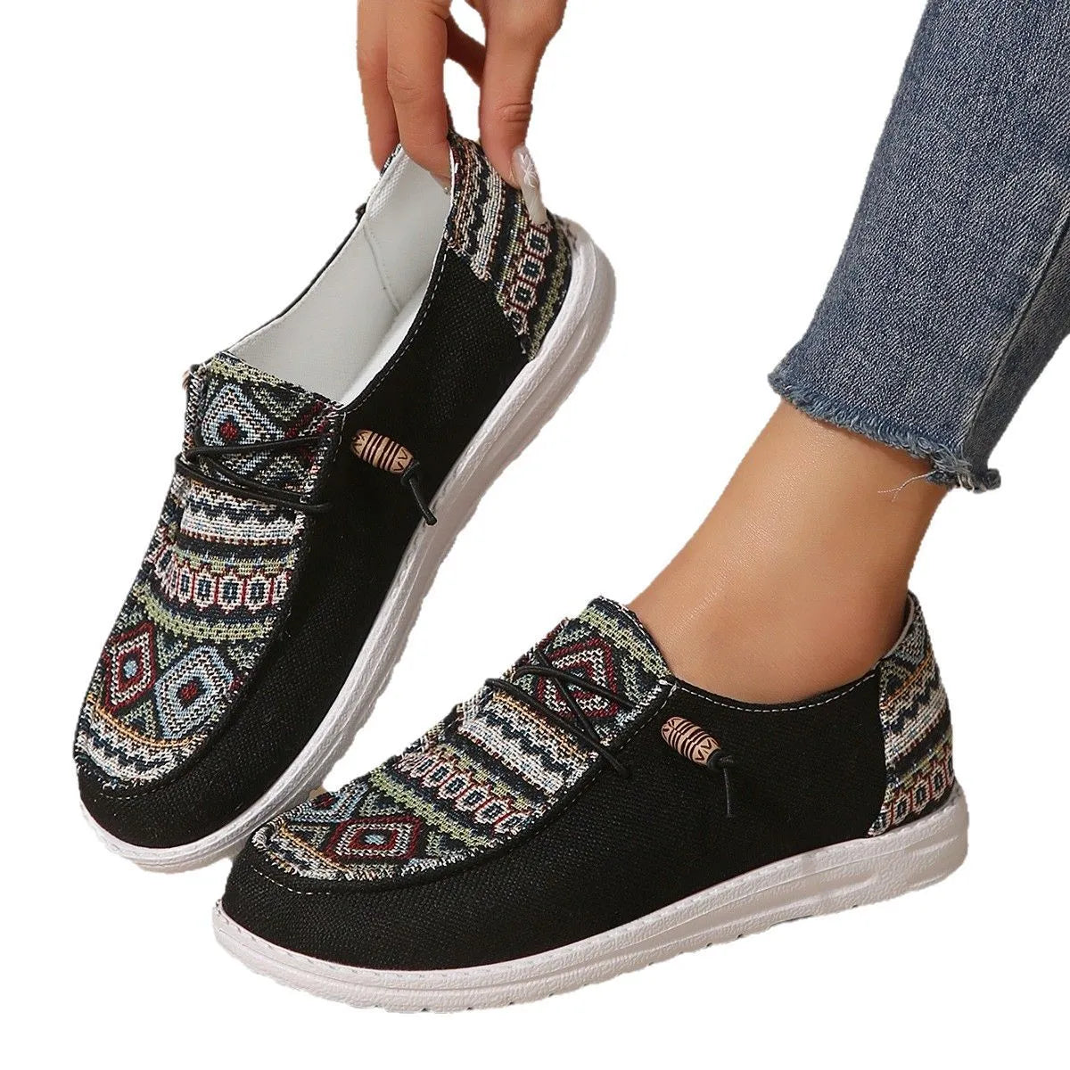 Women's black round toe low-top flat shoes with artificial PU upper and rubber sole on a white background