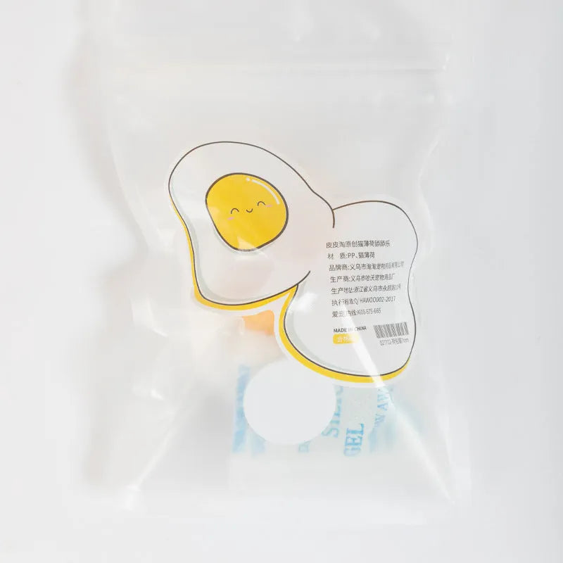 Interactive plush catnip ball toy stuck on a wall, showing Fried Egg and Poached Egg shape options.