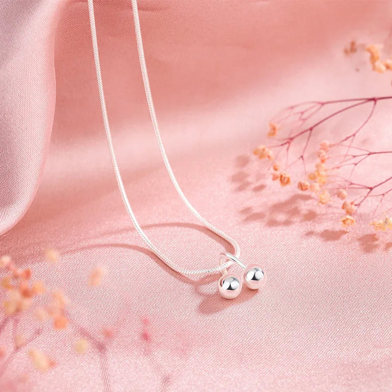 Silver cherry pendant necklace on a snake bone chain, adjustable from 21cm to 50cm.