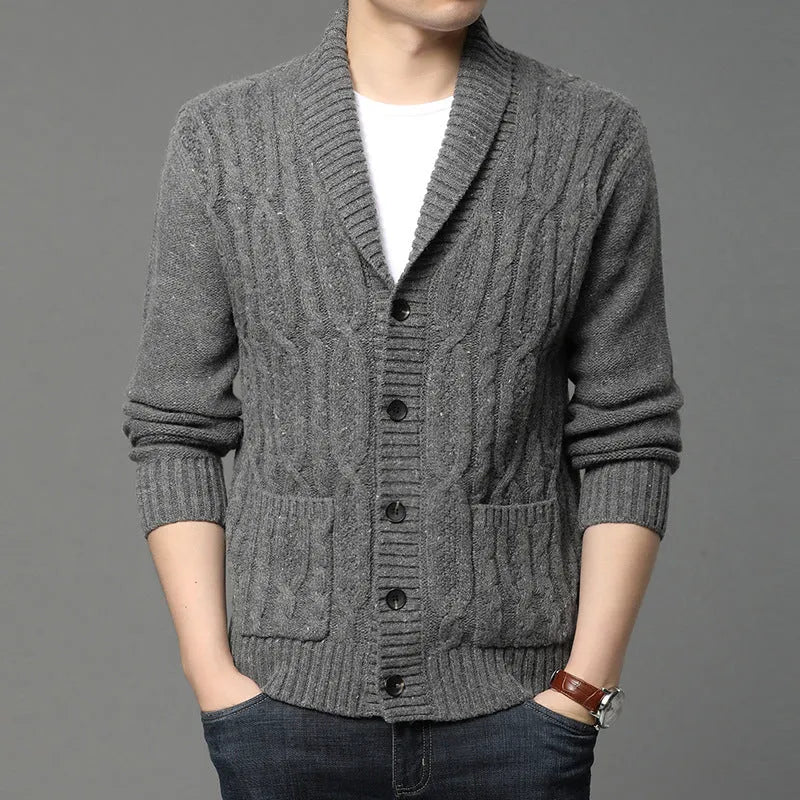 Man wearing a dark grey jacquard knit cardigan jacket with a straight cut and open front.
